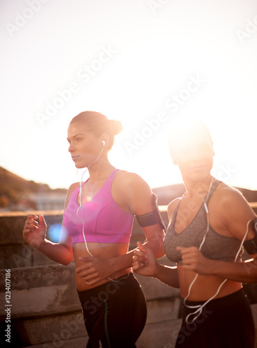 Friends, women and running with music outdoor for cardio workout, endurance challenge and listening to radio. Mockup, flare or people with teamwork for fitness jog, sport training or healthy exercise