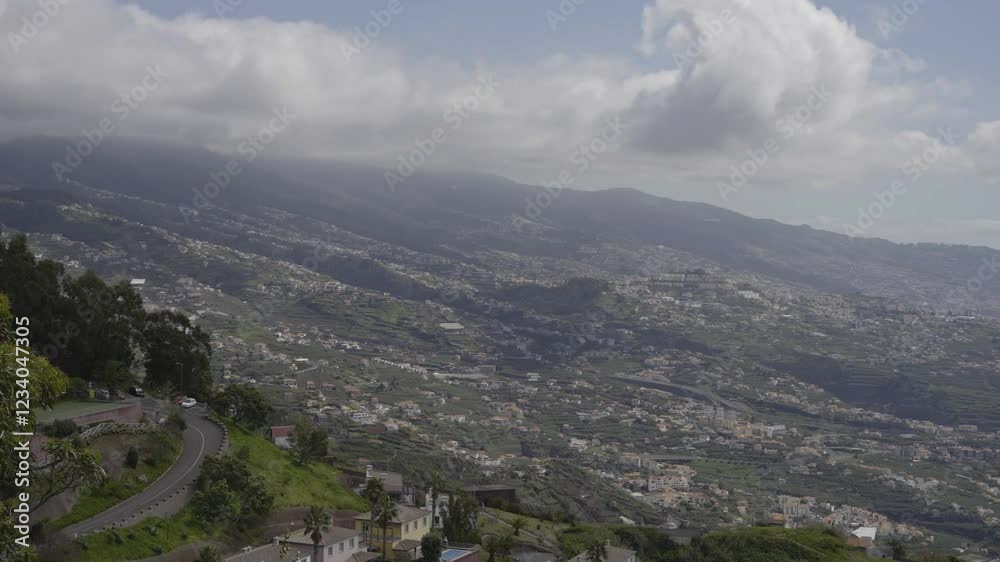 A wide view from Cabo Girão, showcasing the rolling hills, terraced landscapes, and picturesque villages of Madeira. Captures the beauty of the island from one of its most iconic viewpoints. A wide view from Cabo Girão, showcasing the rolling hills, terraced landscapes, and picturesque villages of Madeira. Captures the beauty of the island from one of its most iconic viewpoints.