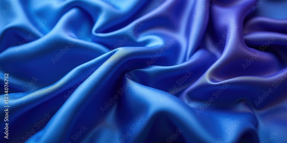 Fototapeta premium Vibrant deep blue satin fabric glistens with smooth, glossy texture; intricate folds and creases evoke dynamic movement in every detail