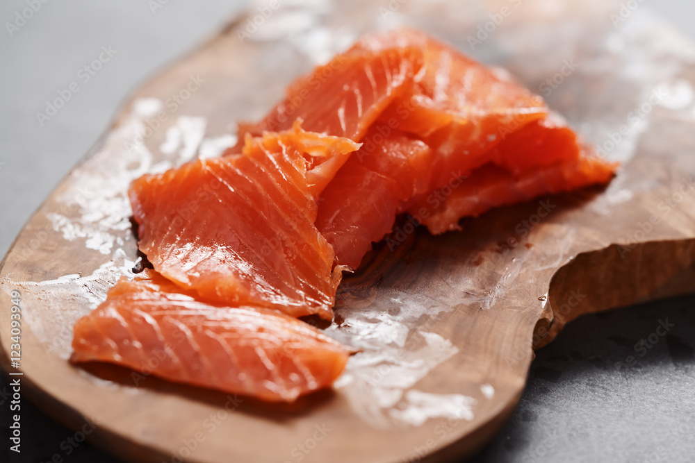 Smoked salted salmon slices on wood board Smoked salted salmon slices on wood board