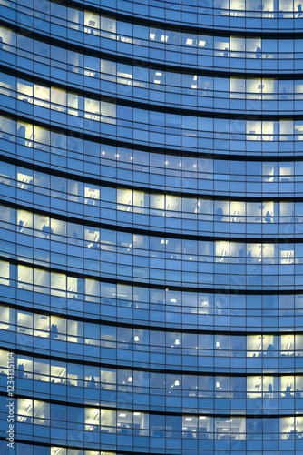 Close up of office windows of modern building in business city center at evening time. Business and finance concept. Abstract architecture background