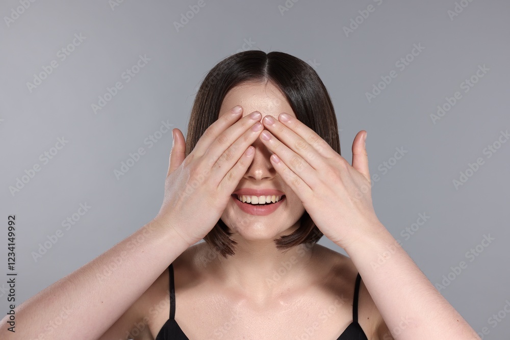 Happy smiling woman with gorgeous straight hair on light grey background Happy smiling woman with gorgeous straight hair on light grey background