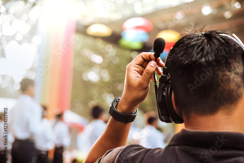 Stage manager using wireless intercom headset while watching and directing stage live performance