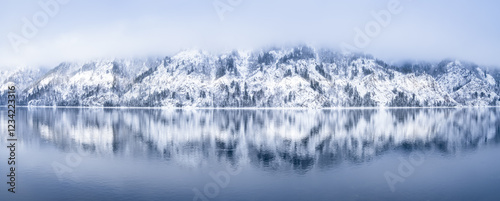A Picturesque Winter Landscape of SnowCovered Mountains and a Calm Lake Reflection at Dusk, Snow-capped mountains with pine trees, reflection in the Yenisei river, beautiful winter background.