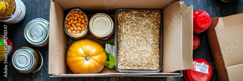 A top-down view of a food donation box with non-perishable items