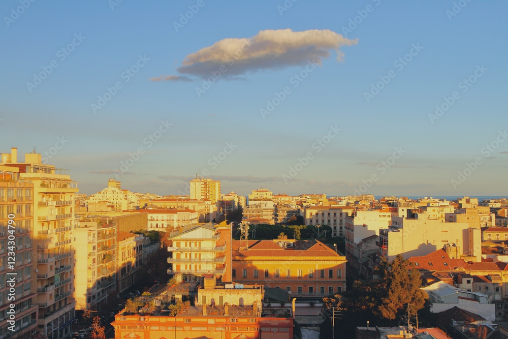 City and a cloud at sunset. Catania, Sicily, Italy