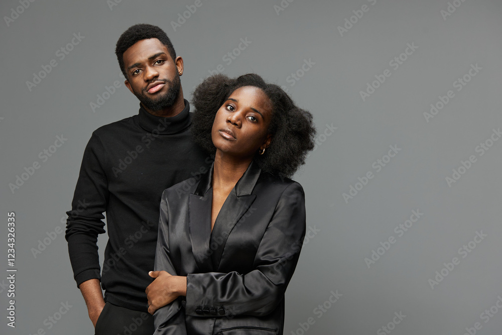 Two stylish young adults with confident expressions pose in modern fashion, embodying sleek aesthetics, showcasing diversity and contemporary elegance Two stylish young adults with confident expressions pose in modern fashion, embodying sleek aesthetics, showcasing diversity and contemporary elegance