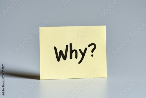 A yellow sticky note captures attention with the bold black letters spelling out Why? in the center, offering a moment of reflection against a clean white background