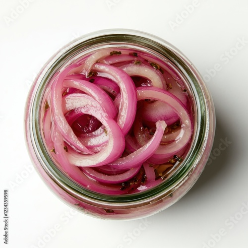 A glass jar filled with vibrant pink pickled red onions sits isolated against a clean white backdrop. The sharp focus highlights the colorful brine and onion slices, emphasizing simplicity