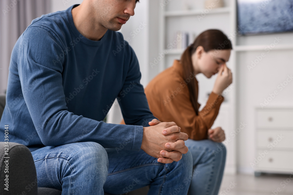 Offended couple ignoring each other at home, selective focus Offended couple ignoring each other at home, selective focus