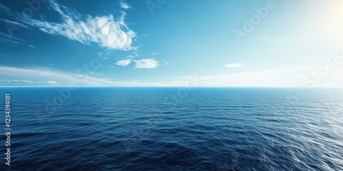 Calm ocean view with clear blue skies and gentle waves under the sunlight.
