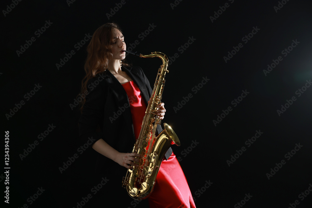 Naklejka premium Professional musician playing saxophone on black background. Space for text