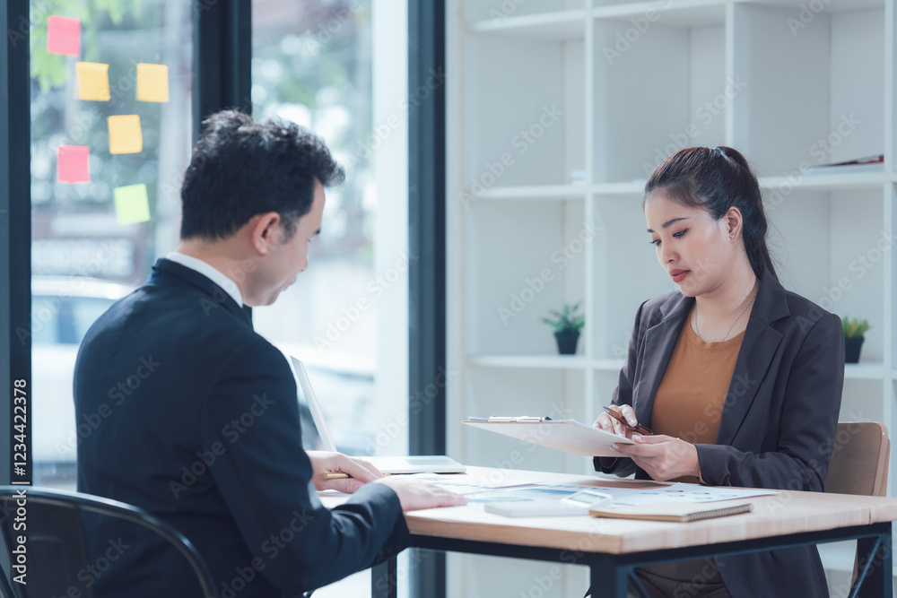 Business Meeting: A serious and focused business meeting in a modern office space, with two individuals reviewing documents, symbolizing effective communication and professional engagement. Business Meeting: A serious and focused business meeting in a modern office space, with two individuals reviewing documents, symbolizing effective communication and professional engagement.