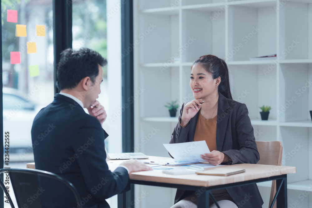 Business Meeting: A focused discussion unfolds between a man and a woman in a modern office setting. The atmosphere is professional yet approachable. Business Meeting: A focused discussion unfolds between a man and a woman in a modern office setting. The atmosphere is professional yet approachable.