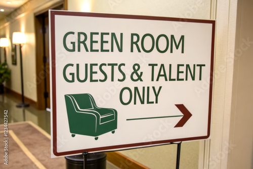 A sign indicating the green room designated for guests and talent, featuring an arrow pointing to the right. photo