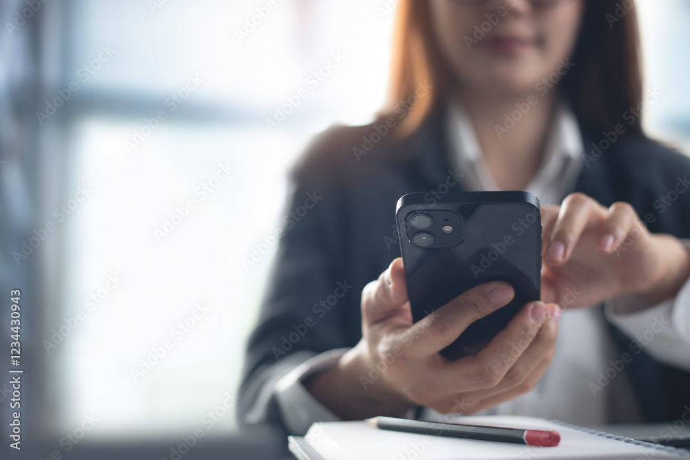 Young smart businesswoman using mobile phone, working on laptop computer at modern office. Young smart businesswoman using mobile phone, working on laptop computer at modern office.
