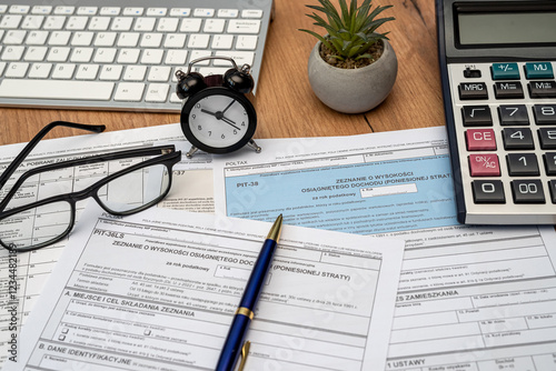 Polish PIT 11 37 38 tax form prepared to be filled with pen calculator glasses on desk photo