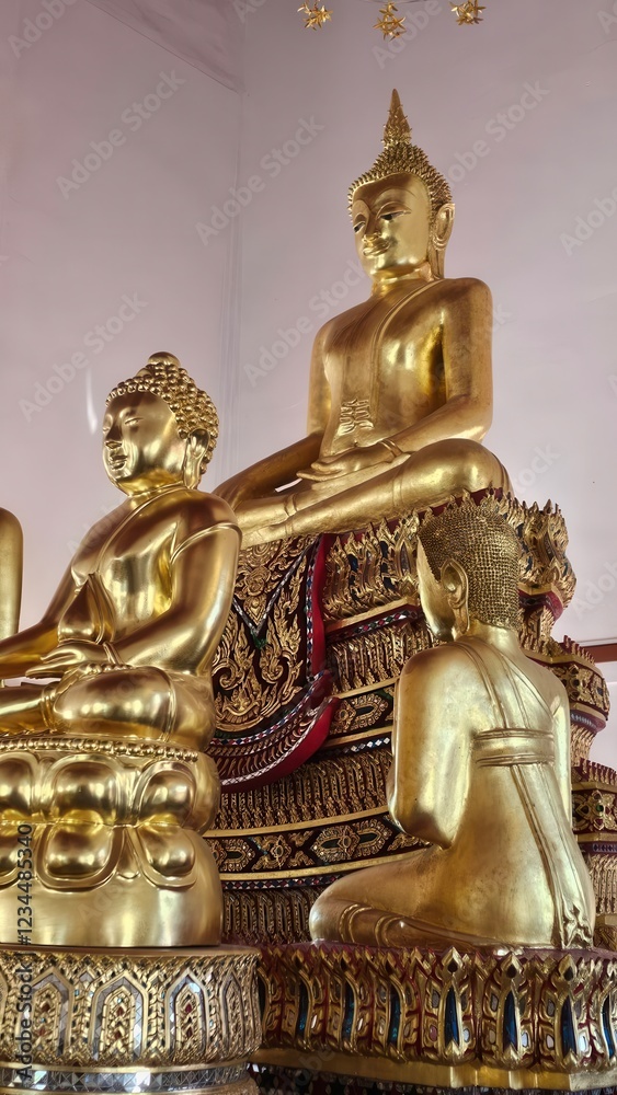 Fototapeta premium Golden Buddha Statues in Serenity at Temple Interior Setting