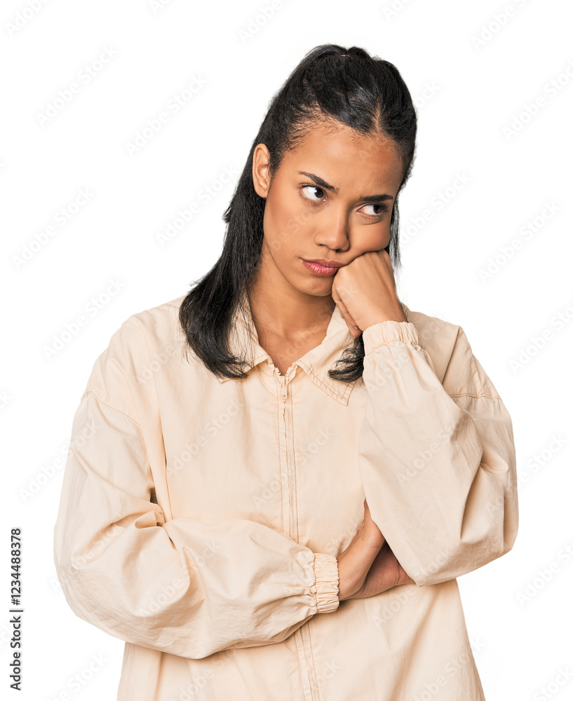 Young Filipina woman who feels sad and pensive, looking at copy space. Young Filipina woman who feels sad and pensive, looking at copy space.