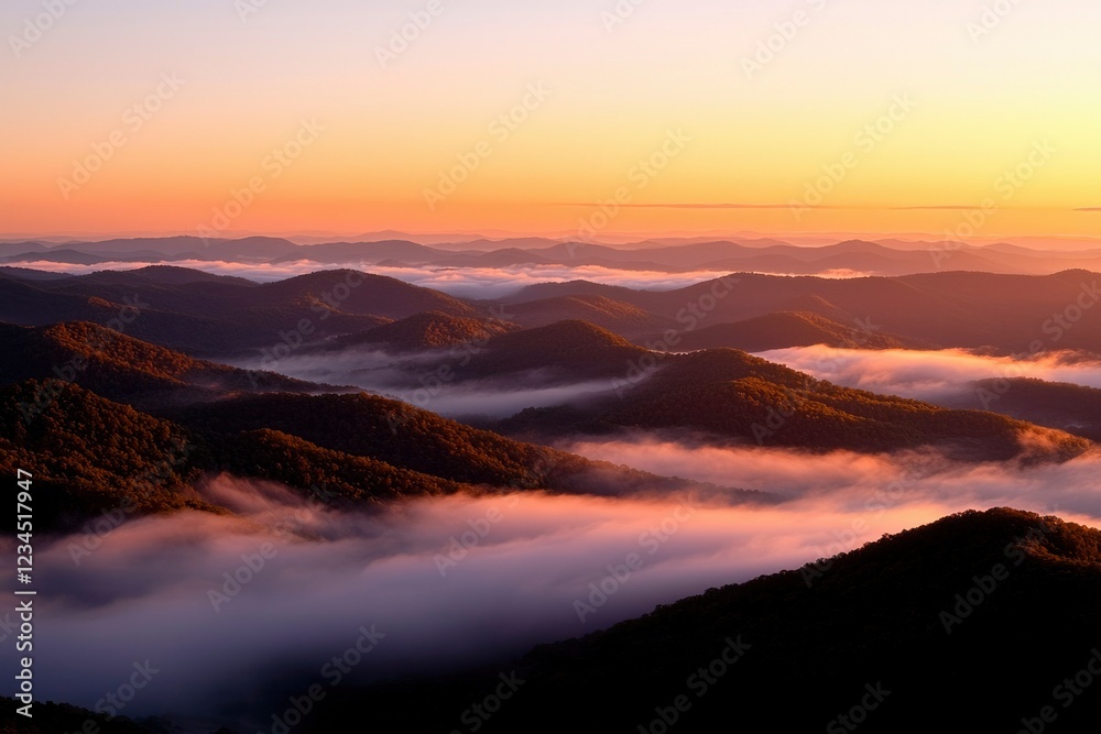 Obraz premium Sunrise Over Rolling Foggy Mountain Ranges