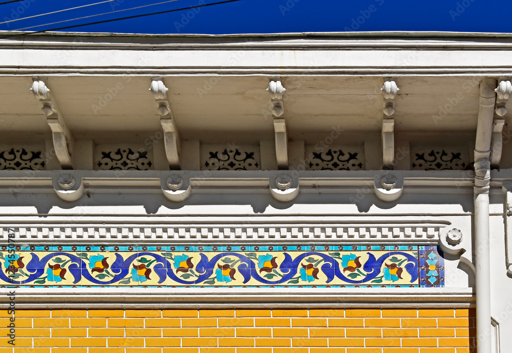 Decorative strip with tiles on yellow facade in Petropolis, Rio de Janeiro, Brazil