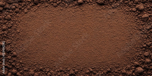 Dark Brown Soil Texture: Rich, dark brown soil forms a natural frame, showcasing its fine texture and earthy tones. Perfect for backgrounds or agricultural themes.