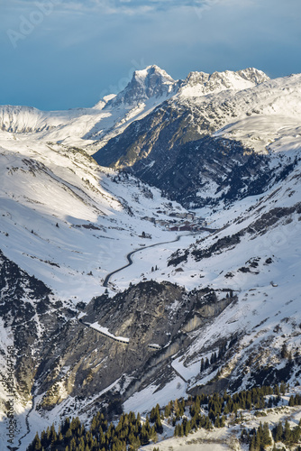 The snow-covered Flexen Pass Road with Flexen Gallery winds through steep rock walls in the Alps between Zürs am Arlberg and Klostertal near Stuben in the Ski Arlberg skiing area. photo