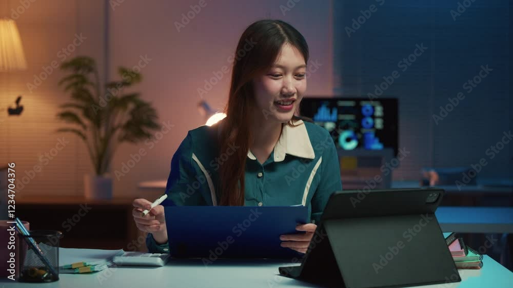 Professional businesswoman reviewing critical documents using tablet and notepad during late-night working session, demonstrating focus and determination at modern workspace with soft lighting Professional businesswoman reviewing critical documents using tablet and notepad during late-night working session, demonstrating focus and determination at modern workspace with soft lighting