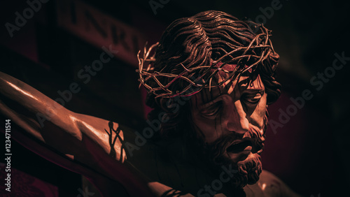 Dark portrait of the face of Christ crucified on the cross.