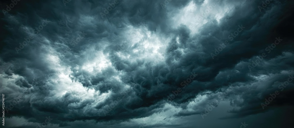 Obraz premium Dramatic dark storm clouds forming ominously in a moody sky with potential for weather changes Copy Space