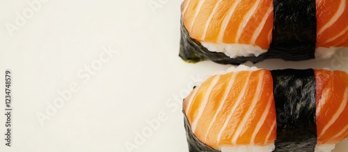 Sushi rolls with salmon on top served on a white background with Copy Space for text placement photo