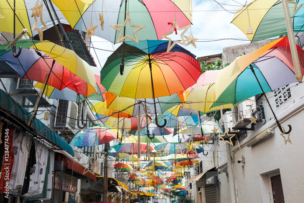 Naklejka premium Beautiful and colorful umbrellas hanging above at George Town, Penang Island, Malaysia. One of favorite photo spot for tourist. Perfect as background or travel wallpaper