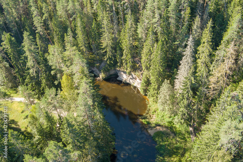 Drone shot of the Ahja River flowing through a forest in Taevaskoja. photo