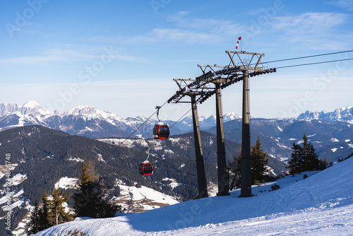 View of red gondolas of cable car  and ski slope in Flachau, Austrian Alps, Snow Space Salzburg, part of Ski Amade skiing area photo