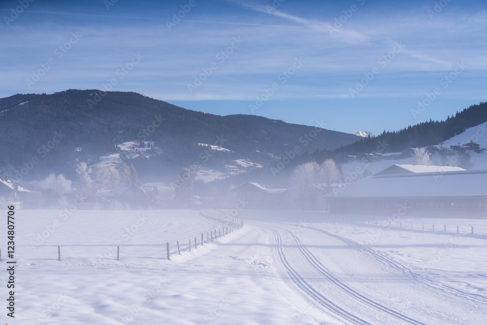 Morning fog over the cross country skiing area in Flachau, Austria. Tranquil scene with groomed cross country skiing trails Morning fog over the cross country skiing area in Flachau, Austria. Tranquil scene with groomed cross country skiing trails