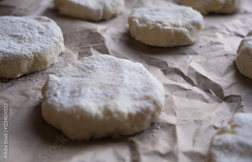 Baking cookies. Closed bakery dough on bakery paper close up.