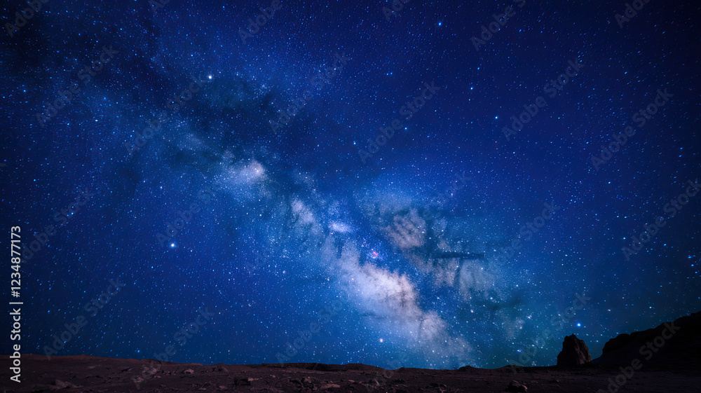 Fototapeta premium Starry Night Sky, Vast Expanses Filled with Twinkling Stars, Deep Dark Blue Backdrop, Celestial Wonders Visible, Peaceful and Majestic Atmosphere of the Night Sky