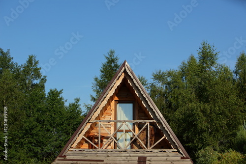 Charming AFrame Cabin Nestled Surrounded by Lush, Vibrant Greenery, Perfect for Relaxation photo