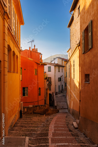 Fototapeta Naklejka Na Ścianę i Meble -  Street in Menton, narrow houses, narrow streets, magical old part of Menton.