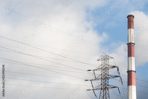 High voltage transmission lines and a chimney emitting harmful greenhouse gases into the atmosphere.
