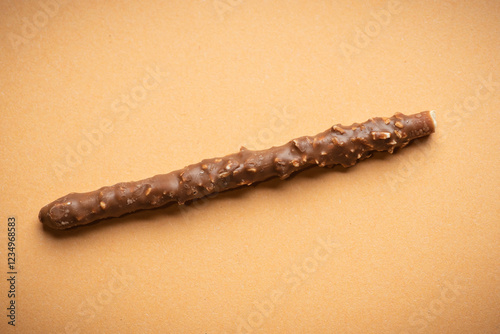 Chocolate Coated Snack Stick with Nuts on Brown