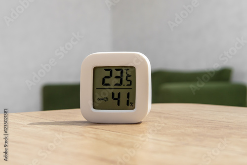 Small digital indoor temperature and humidity meter. Temperature sensor in living room. Temperature control