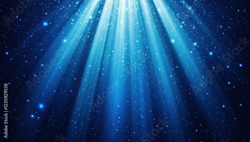 Bright blue light rays shining down on dark blue background with sparkles.