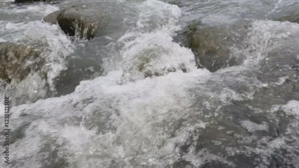 Slow motion of clear river water flow.Rocky forest river.Ecology and environment concept.Calm water flow for relaxation