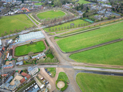 Aerial view of the start of the Newmarket training gallops seen adjacent to horse racing stables. Private apartments are located nearby, overlooking the famous Gallops. photo