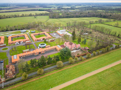 Aerial view of a large and modern horse racing livery yard and stables seen near the famous Suffolk, UK town of Newmarket. Various equine therapy units can be seen. photo