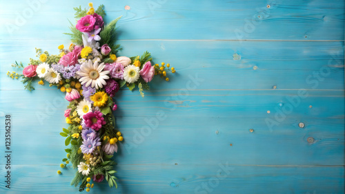 Floral cross on blue wooden background