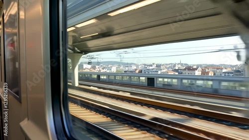 Close up view from a window of a train moving on the rails near a station in Nice, France