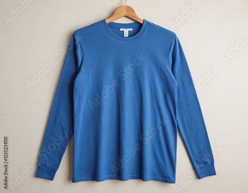 Long-sleeve blue shirt displayed on a wooden hanger against a neutral background.