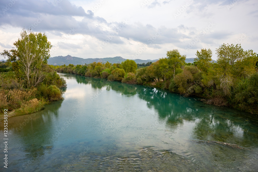 Seljuk bridge in Aspendos. The Eurymedon Bridge. Aspendos Yolu Belkis Mevkii. Turkey. Crooked bridge. Bridge over the Koprucay (Euremedon) River near Aspendos, in Pamphylia, in southern Anatolia Seljuk bridge in Aspendos. The Eurymedon Bridge. Aspendos Yolu Belkis Mevkii. Turkey. Crooked bridge. Bridge over the Koprucay (Euremedon) River near Aspendos, in Pamphylia, in southern Anatolia